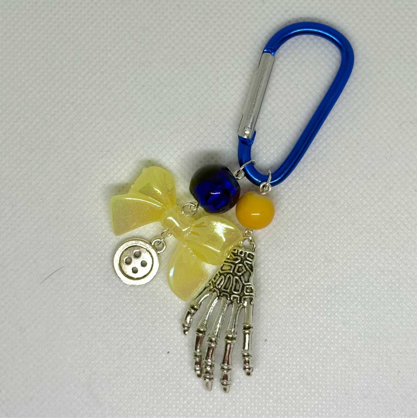 yellow and blue carabiner bag charm keychain coraline button skeleton the other mother