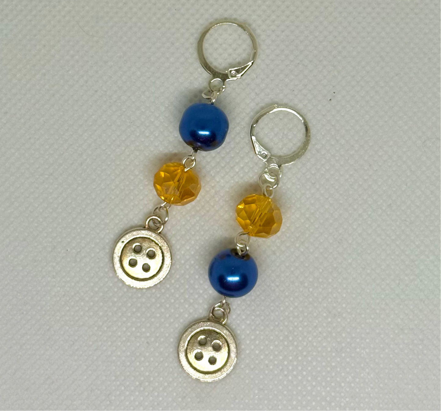 blue and yellow coraline button earrings halloween