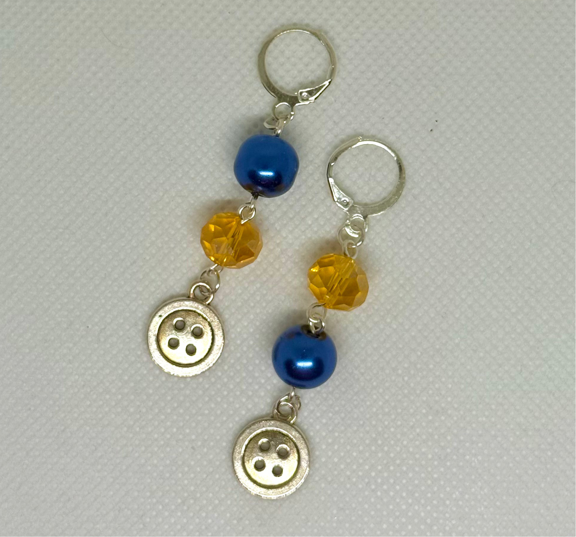 blue and yellow coraline button earrings halloween